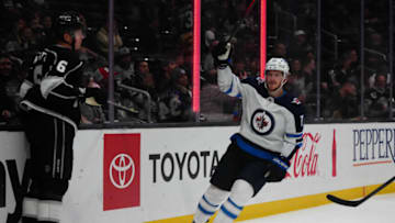 Oct 28, 2021; Los Angeles, California, USA; Winnipeg Jets left wing Evgeny Svechnikov (71) celebrates after a Jets goal in the third period as LA Kings defenseman Olli Maatta (6) watches at Staples Center. The Jets defeated the Kings 3-2. Mandatory Credit: Kirby Lee-USA TODAY Sports