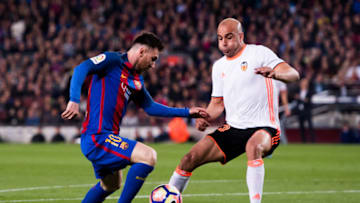 BARCELONA, SPAIN - MARCH 19: Lionel Messi (L) of FC Barcelona dribbles Aymen Abdennour of Valencia CF before scoring his team's third goal during the La Liga match between FC Barcelona and Valencia CF at Camp Nou stadium on March 19, 2017 in Barcelona, Spain. (Photo by Alex Caparros/Getty Images)