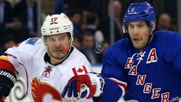 Feb 24, 2015; New York, NY, USA; Calgary Flames left wing Lance Bouma (17) and New York Rangers defenseman Dan Girardi (5) keep their eyes on the puck during the first period at Madison Square Garden. Mandatory Credit: Adam Hunger-USA TODAY Sports