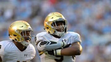 Oct 7, 2017; Chapel Hill, NC, USA; Notre Dame Fighting Irish defensive lineman Daelin Hayes (9) reacts with defensive lineman Julian Okwara (42) after sacking North Carolina Tar Heels quarterback Chazz Surratt (12) (not pictured) in the third quarter at Kenan Memorial Stadium. Mandatory Credit: Bob Donnan-USA TODAY Sports