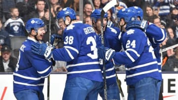 TORONTO, ON - MARCH 15: Connor Carrick #8 of the Toronto Maple Leafs celebrates with teammates his first goal as Toronto Maple Leaf during a game on March 15, 2016 at Air Canada Centre in Toronto, Ontario, Canada. (Photo by Graig Abel/NHLI via Getty Images)