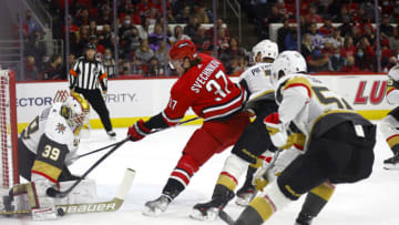 RALEIGH, NORTH CAROLINA - JANUARY 25: Laurent Brossoit #39 of the Vegas Golden Knights denies a shot attempt from Andrei Svechnikov #37 of the Carolina Hurricanes during the first period of the game at PNC Arena on January 25, 2022 in Raleigh, North Carolina. (Photo by Jared C. Tilton/Getty Images)