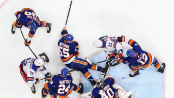 UNIONDALE, NEW YORK - JANUARY 16: Adam Fox #23 of the New York Rangers is stopped by the New York Islanders during the second period at NYCB Live's Nassau Coliseum on January 16, 2020 in Uniondale, New York. The Rangers defeated the Islanders 3-2. (Photo by Bruce Bennett/Getty Images)