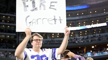 ARLINGTON, TX - NOVEMBER 05: A Dallas Cowboys fan holds up a sign that says "Fire Garrett" after the Tennessee Titans scored a touchdown in the fourth quarter of a football game at AT&T Stadium on November 5, 2018 in Arlington, Texas. (Photo by Tom Pennington/Getty Images)