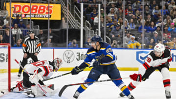 Nov 3, 2023; St. Louis, Missouri, USA; St. Louis Blues center Jordan Kyrou (25) shoots as New Jersey Devils goaltender Akira Schmid (40) and defenseman Kevin Bahl (88) defend during the third period at Enterprise Center. Mandatory Credit: Jeff Curry-USA TODAY Sports