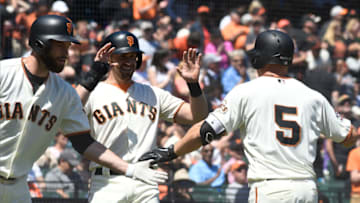 SAN FRANCISCO, CA - MAY 02: Nick Hundley #5 of the San Francisco Giants is congratulated by Brandon Belt #9 and Evan Longoria #10 after Hundley hit a two-run home run against the San Diego Padres in the bottom of the fourth inning at AT&T Park on May 2, 2018 in San Francisco, California. (Photo by Thearon W. Henderson/Getty Images)