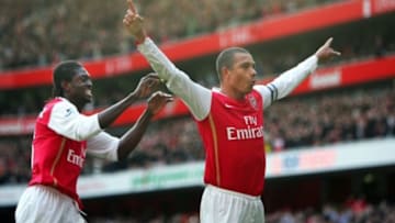 London, UNITED KINGDOM: Arsenal's Emmanuel Adebayor (L) comes to join team Captain Gilberto Silva (R) as he celebrates scoring his second penalty, and their third goal against Tottenham Hotspur during the Premiership football match at The Emirates Stadium in London 02 December 2006. Arsenal won the game 3-0. AFP PHOTO ADRIAN DENNIS Mobile and website uses of domestic English football pictures subject to subscription of a license with Football Association Premier League (FAPL) tel : 44 207 298 1656. For newspapers where the football content of the printed and electronic versions are identical, no licence is necessary. (Photo credit should read ADRIAN DENNIS/AFP/Getty Images)