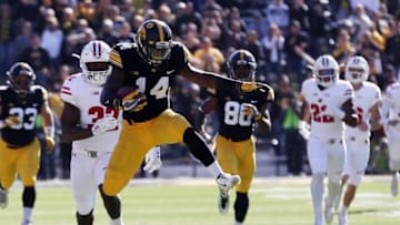 Oct 22, 2016; Iowa City, IA, USA; Iowa Hawkeyes kick returner Desmond King (14) hurdles his own player against the Wisconsin Badgers at Kinnick Stadium. The Badgers beat the Hawkeyes 17 to 9. Mandatory Credit: Reese Strickland-USA TODAY Sports