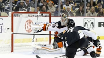 Oct 9, 2014; Pittsburgh, PA, USA; Anaheim Ducks goalie John Gibson (36) blocks a shot by Pittsburgh Penguins defenseman Paul Martin (7) during the second period at the CONSOL Energy Center. The Penguins won 6-4. Mandatory Credit: Charles LeClaire-USA TODAY Sports