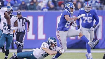 Jan 3, 2016; East Rutherford, NJ, USA; Philadelphia Eagles safety Ed Reynolds (30) trips up New York Giants running back Rashad Jennings (23) during the second half at MetLife Stadium. The Eagles won 35-30. Mandatory Credit: Jim O