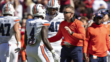 FAYETTEVILLE, ARKANSAS - OCTOBER 16: Tank Bigsby #4 is congratulated by Head Coach Bryan Harsin of the Auburn Tigers during a game against the Arkansas Razorbacks at Donald W. Reynolds Stadium on October 16, 2021 in Fayetteville, Arkansas. The Tigers defeated the Razorbacks 38-23. (Photo by Wesley Hitt/Getty Images)