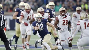 SOUTH BEND, IN - NOVEMBER 23: Ian Book #12 of the Notre Dame Fighting Irish runs with the ball against the Boston College Eagles in the first quarter at Notre Dame Stadium on November 23, 2019 in South Bend, Indiana. (Photo by Joe Robbins/Getty Images)