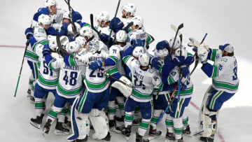 EDMONTON, ALBERTA - AUGUST 07: The Vancouver Canucks celebrate their 5-4 win on a goal by Christopher Tanev #8 at :11 in overtime to defeat the Minnesota Wild in Game Four and the Western Conference Qualification Round prior to the 2020 NHL Stanley Cup Playoffs at Rogers Place on August 07, 2020 in Edmonton, Alberta. (Photo by Jeff Vinnick/Getty Images)