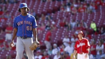 Sep 7, 2014; Cincinnati, OH, USA; New York Mets relief pitcher Jenrry Mejia (58) waits at the mound during a replay review in the ninth inning at Great American Ball Park. Cincinnati Reds third baseman Todd Frazier waits at first base at right. The Mets won 4-3. Mandatory Credit: David Kohl-USA TODAY Sports