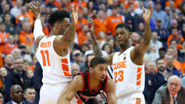 SYRACUSE, NY - FEBRUARY 20: Christen Cunningham #1 of the Louisville Cardinals looks to pass between the defense of Oshae Brissett #11 and Frank Howard #23 of the Syracuse Orange during the first half at the Carrier Dome on February 20, 2019 in Syracuse, New York. (Photo by Rich Barnes/Getty Images)