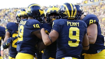 Sep 17, 2016; Ann Arbor, MI, USA; Michigan Wolverines linebacker Jabrill Peppers (center) receives congratulations from teammates after he scores a touchdown in the second half against the Colorado Buffaloes at Michigan Stadium. Michigan won 45-28. Mandatory Credit: Rick Osentoski-USA TODAY Sports