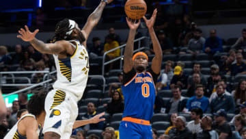 Oct 12, 2022; Indianapolis, Indiana, USA; New York Knicks forward Cam Reddish (0) shoots the ball while Indiana Pacers forward Isaiah Jackson (22) defends in the first half at Gainbridge Fieldhouse. Mandatory Credit: Trevor Ruszkowski-USA TODAY Sports