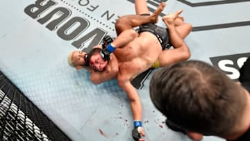 ABU DHABI, UNITED ARAB EMIRATES - JULY 19: In this handout image provided by UFC, (L-R) Deiveson Figueiredo of Brazil secures a rear choke submission against Joseph Benavidez in their UFC flyweight championship bout during the UFC Fight Night event inside Flash Forum on UFC Fight Island on July 19, 2020 in Yas Island, Abu Dhabi, United Arab Emirates. (Photo by Jeff Bottari/Zuffa LLC via Getty Images)