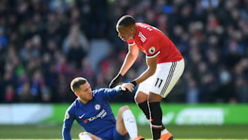 MANCHESTER, ENGLAND - FEBRUARY 25: Eden Hazard of Chelsea is helped up by Anthony Martial of Manchester United during the Premier League match between Manchester United and Chelsea at Old Trafford on February 25, 2018 in Manchester, England. (Photo by Laurence Griffiths/Getty Images)