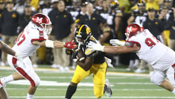 IOWA CITY, IOWA- AUGUST 31: Running back Tyler Goodson #15 of the Iowa Hawkeyes rushes up field during the second half between defensive lineman Austin Ertl #92 and Will Kellison #97 of the Miami Ohio RedHawks on August 31, 2019 at Kinnick Stadium in Iowa City, Iowa. (Photo by Matthew Holst/Getty Images)