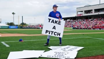 Mar 12, 2015; Tempe, AZ, USA; Chicago Cubs base coach Will Ferrell (19) holds a sign during the third inning against the Los Angeles Angels at Tempe Diablo Stadium. Mandatory Credit: Matt Kartozian-USA TODAY Sports