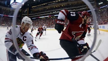 Feb 4, 2016; Glendale, AZ, USA; Chicago Blackhawks center Jonathan Toews (19) checks Arizona Coyotes defenseman Oliver Ekman-Larsson (23) during the second period at Gila River Arena. Mandatory Credit: Joe Camporeale-USA TODAY Sports