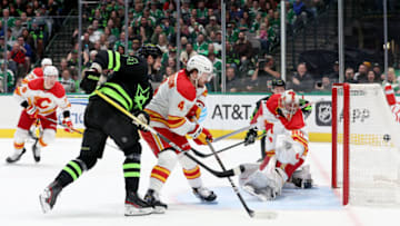 DALLAS, TEXAS - JANUARY 14: Jamie Benn #14 of the Dallas Stars scores a goal against Dan Vladar #80 of the Calgary Flames as Rasmus Andersson #4 of the Calgary Flames defends in the first period at American Airlines Center on January 14, 2023 in Dallas, Texas. (Photo by Tom Pennington/Getty Images)