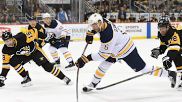 PITTSBURGH, PA - NOVEMBER 19: Marco Scandella #6 of the Buffalo Sabres attempts a shot as Patric Hornqvist #72 of the Pittsburgh Penguins defends during the first period in the game at PPG PAINTS Arena on November 19, 2018 in Pittsburgh, Pennsylvania. (Photo by Justin Berl/Getty Images)