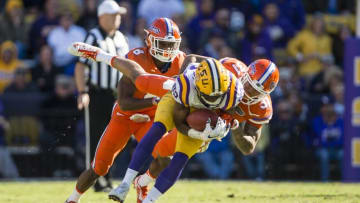 Nov 19, 2016; Baton Rouge, LA, USA; LSU Tigers wide receiver D.J. Chark (82) is tackled by Florida Gators defensive back Teez Tabor (31) during the second half at Tiger Stadium. The Gators defeat the Tigers 16-10. Mandatory Credit: Jerome Miron-USA TODAY Sports
