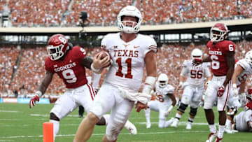 DALLAS, TX - OCTOBER 06: Sam Ehlinger #11 of the Texas Longhorns smiles as he runs into the endzone for a touchdown against the Oklahoma Sooners in the second quarter of the 2018 AT&T Red River Showdown at Cotton Bowl on October 6, 2018 in Dallas, Texas. (Photo by Ronald Martinez/Getty Images)