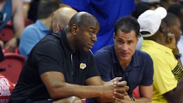 LAS VEGAS, NV - JULY 07: Los Angeles Lakers president of basketball operations Earvin "Magic" Johnson (L) and Lakers general manager Rob Pelinka talk during a 2017 Summer League game between the Lakers and the Los Angeles Clippers at the Thomas & Mack Center on July 7, 2017 in Las Vegas, Nevada. The Clippers won 96-93 in overtime. NOTE TO USER: User expressly acknowledges and agrees that, by downloading and or using this photograph, User is consenting to the terms and conditions of the Getty Images License Agreement. (Photo by Ethan Miller/Getty Images)