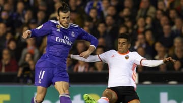 VALENCIA, SPAIN - FEBRUARY 22: Gareth Bale (L) of Real Madrid is tackled by Joao Cancelo of Valencia during the La Liga match between Valencia CF and Real Madrid at Mestalla Stadium on February 22, 2017 in Valencia, Spain. (Photo by Manuel Queimadelos Alonso/Getty Images)