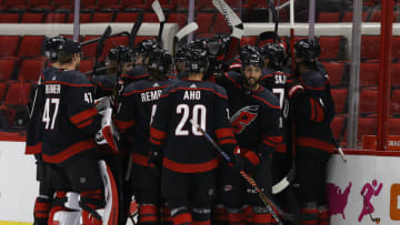 RALEIGH, NORTH CAROLINA - JANUARY 28: The Carolina Hurricanes celebrate after Martin Necas #88 scored the game-winning goal in overtime of their game against the Tampa Bay Lightning at PNC Arena on January 28, 2021 in Raleigh, North Carolina. (Photo by Jared C. Tilton/Getty Images)