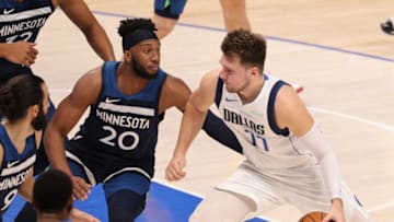 Luka Doncic of the Dallas Mavericks dribbles the ball against Josh Okogie of the Minnesota Timberwolves. (Photo by Ronald Martinez/Getty Images)