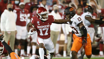 Nov 21, 2020; Norman, Oklahoma, USA; Oklahoma Sooners wide receiver Marvin Mims (17) runs as Oklahoma State Cowboys cornerback Thomas Harper (13) defends during the first half at Gaylord Family-Oklahoma Memorial Stadium. Mandatory Credit: Kevin Jairaj-USA TODAY Sports
