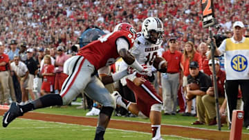 Sep 19, 2015; Athens, GA, USA; South Carolina Gamecocks quarterback Perry Orth (10) scores a touchdown past Georgia Bulldogs linebacker Leonard Floyd (84) during the first half at Sanford Stadium. Mandatory Credit: Dale Zanine-USA TODAY Sports