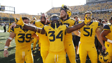 MORGANTOWN, WV - OCTOBER 06: West Virginia Mountaineers players celebrate after the game against the Kansas Jayhawks at Mountaineer Field on October 6, 2018 in Morgantown, West Virginia. The Mountaineers won 38-22. (Photo by Joe Robbins/Getty Images)