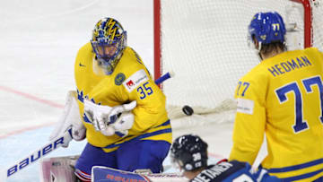 COLOGNE, GERMANY - MAY 20, 2017: Sweden's goaltender Henrik Lundqvist (L) concedes a goal as teammate Victor Hedman (R), and Finland's Juuso Hietanen (C) look on in their 2017 IIHF Ice Hockey World Championship semifinal match at Lanxess Arena; Sweden won 4-1. Anton Novoderezhkin/TASS (Photo by Anton NovoderezhkinTASS via Getty Images)