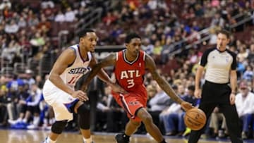 Jan 31, 2014; Philadelphia, PA, USA; Atlanta Hawks guard Louis Williams (3) is defended by Philadelphia 76ers guard Evan Turner (12) during the second quarter at the Wells Fargo Center. Mandatory Credit: Howard Smith-USA TODAY Sports