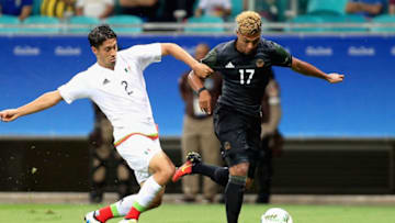 SALVADOR, BAHIA - AUGUST 04: Serge Gnabry of Germany is challenged by Jose Abella of Mexico during the Men's Group C first round match between Mexico and Germany during the Rio 2016 Olympic Games at Arena Fonte Nova on August 4, 2016 in Salvador, Brazil. (Photo by Felipe Oliveira/Getty Images)
