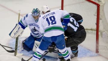 Nov 6, 2014; San Jose, CA, USA; Vancouver Canucks goalie Ryan Miller (30) blocks a shot by San Jose Sharks center Patrick Marleau (12) during the first period at SAP Center at San Jose. Mandatory Credit: Ed Szczepanski-USA TODAY Sports