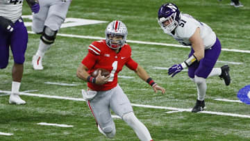 Ohio State Buckeyes quarterback Justin Fields (1) rushes upfield ahead of Northwestern Wildcats linebacker Blake Gallagher (51) during the first quarter of the Big Ten Championship football game at Lucas Oil Stadium in Indianapolis on Saturday, Dec. 19, 2020.Big Ten Championship Ohio State Northwestern