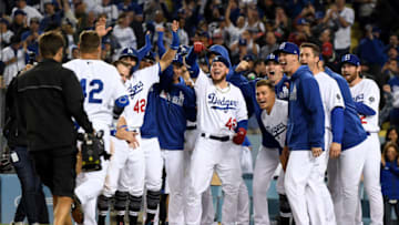 LOS ANGELES, CALIFORNIA - APRIL 15: The Los Angeles Dodgers wait for Joc Pederson #42 at home plate after his two run homerun for a 4-3 win over the Cincinnati Reds during the bottom of the ninth inning on Jackie Robinson Day at Dodger Stadium on April 15, 2019 in Los Angeles, California. All players are wearing the number 42 in honor of Jackie Robinson Day. (Photo by Harry How/Getty Images)
