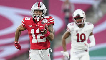 Ohio State Buckeyes wide receiver Emeka Egbuka (12) returns a kickoff ahead of Utah Utes wide receiver Bryson Reeves (19) during the third quarter of the Rose Bowl in Pasadena, Calif. on Jan. 1, 2022.Rose Bowl 04