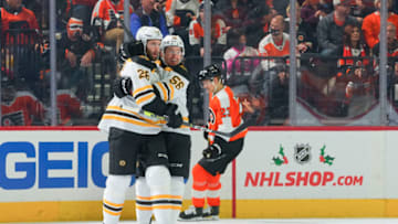 PHILADELPHIA, PA - NOVEMBER 20: Derek Forbort #28 of the Boston Bruins celebrates his goal with Erik Haula #56 in front of Oskar Lindblom #23 of the Philadelphia Flyers in the second period at the Wells Fargo Center on November 20, 2021 in Philadelphia, Pennsylvania. (Photo by Mitchell Leff/Getty Images)