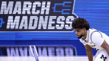 INDIANAPOLIS, INDIANA - MARCH 13: Mike Smith #12 of the Michigan Wolverines brings the ball up the court in the game against the Ohio State Buckeyes during the second half of the Big Ten men's basketball tournament semifinals at Lucas Oil Stadium on March 13, 2021 in Indianapolis, Indiana. (Photo by Justin Casterline/Getty Images)