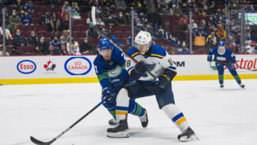 Jan 23, 2022; Vancouver, British Columbia, CAN; Vancouver Canucks defenseman Luke Schenn (2) checks St. Louis Blues forward Robert Thomas (18) in the second period at Rogers Arena. Mandatory Credit: Bob Frid-USA TODAY Sports