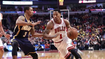 Nov 16, 2013; Chicago, IL, USA; Chicago Bulls point guard Derrick Rose (1) drives around Indiana Pacers point guard George Hill (3)during the second half at the United Center. Chicago won 110-94. Mandatory Credit: Dennis Wierzbicki-USA TODAY Sports