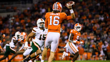 Oct 10, 2020; Clemson, South Carolina, USA; Clemson Tigers quarterback Trevor Lawrence (16) throws to running back Travis Etienne (9) against Miami Hurricanes defensive line Jaelan Phillips (15) during the first quarte at Memorial Stadium. Mandatory Credit: Ken Ruinard-USA TODAY Sports