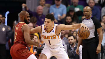 PHOENIX, ARIZONA - FEBRUARY 04: Devin Booker #1 of the Phoenix Suns handles the ball against Chris Paul #3 of the Houston Rockets during the first half of the NBA game at Talking Stick Resort Arena on February 04, 2019 in Phoenix, Arizona. (Photo by Christian Petersen/Getty Images)
